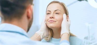 Doctor examining woman's face