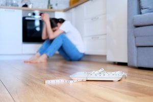 Scale and tape measure on the kitchen floor