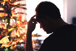 head in hands by Christmas tree