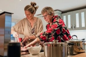 Older woman and adult woman cooking